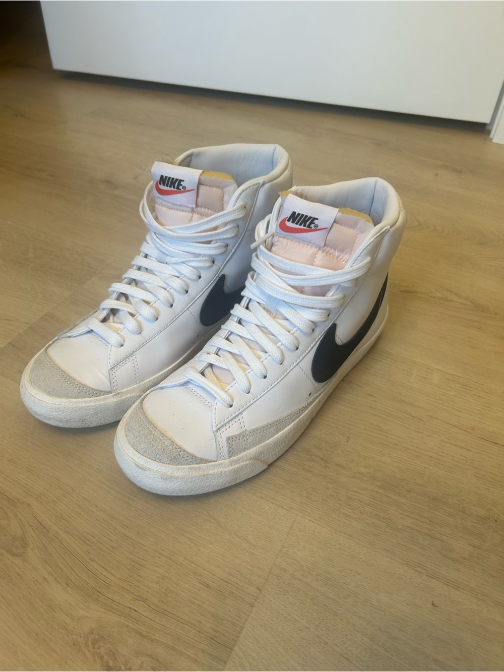 Nike womens White High-Top Sneakers with Black Swoosh and Pink Tongue Detail